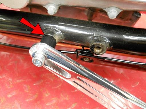 Thread the bolt half way into the rear foot peg