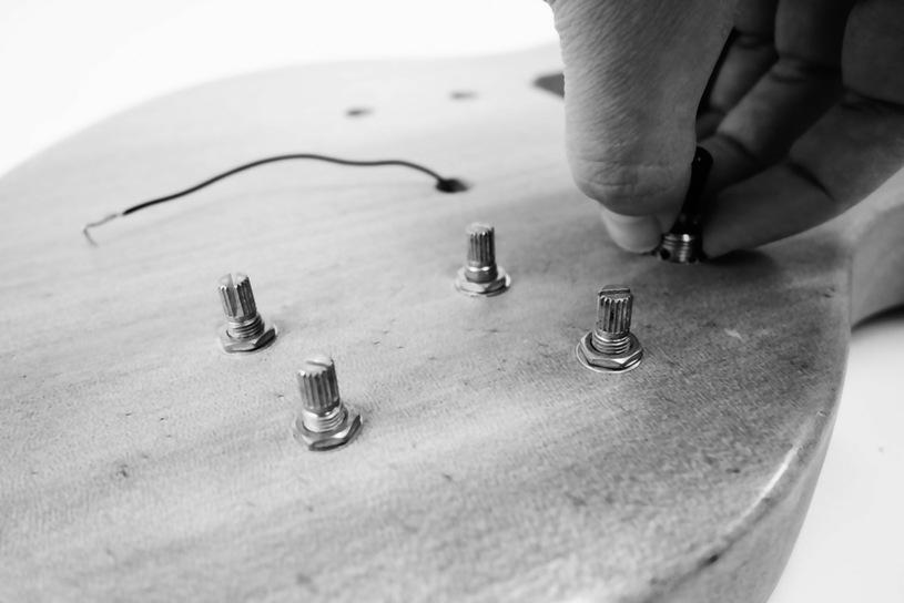 Screw the potentiometers finger-tight to the body surface with a washer and a hex nut each.