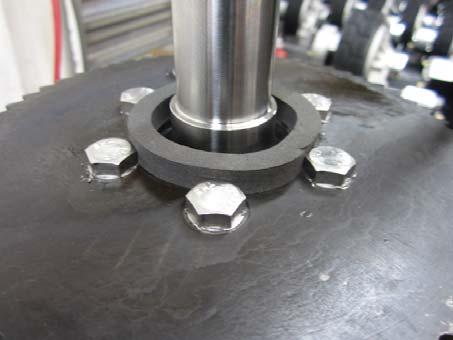 Loosen the nut that is between the Drive Mounting Plate and the sprocket that is on the bolt going through