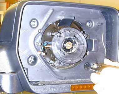 Using one of the supplied Signal mirror wire harness, insert (from the front) the open end (the end without connector) behind motor actuator (A) and out the center hole (B).