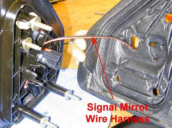 If heated, reconnect the heater wires to the heater terminals on the back of the new Signal mirror (B).
