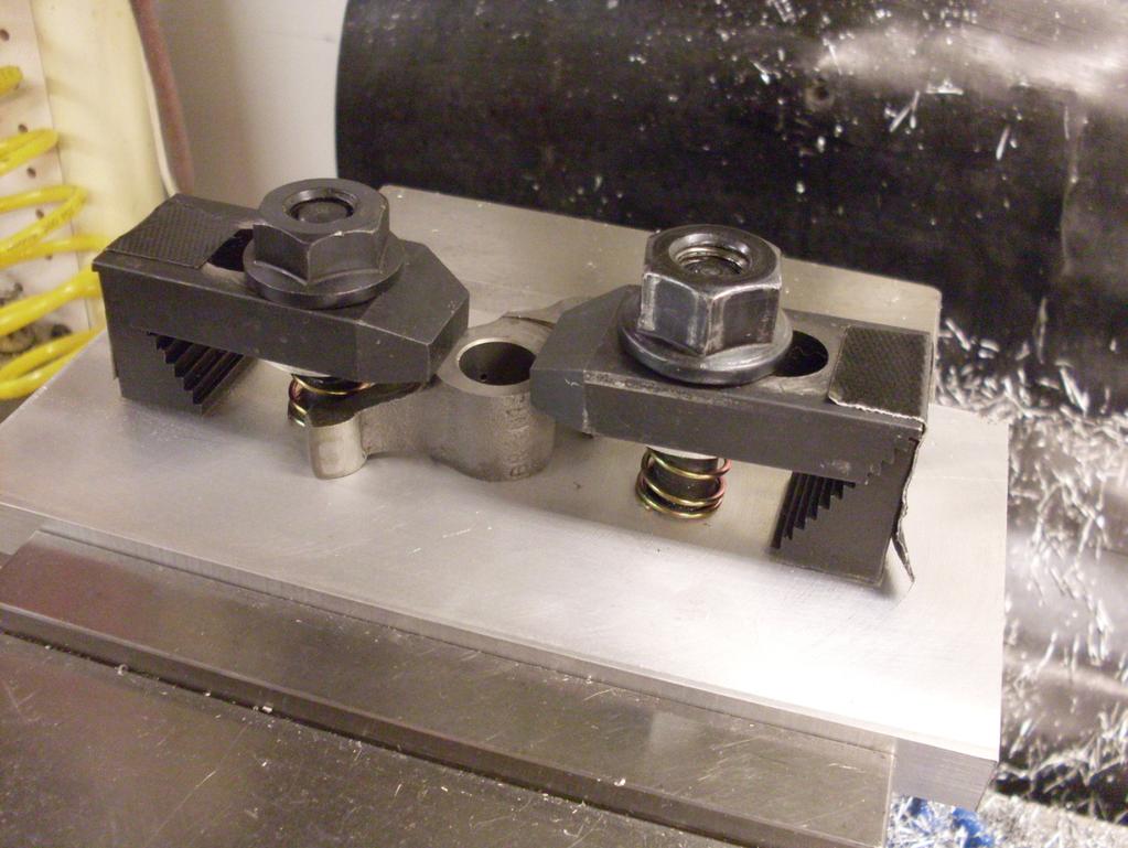 Figure 3. The rocker bushing fixture. The fixture consists of a 1/2" thick aluminum base plate, milled flat and square, fitted with a couple of clamp bolts.