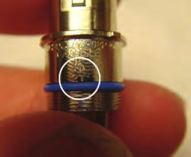 Using a blue insulator from the connector kit, insert the contact into an insulator with the solid colored wire in the hole