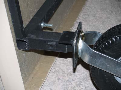 The mounting tab should be facing inside and toward the edge of the coop. Secure with 1/2 x 1 hex bolt and 3/4 wrench.
