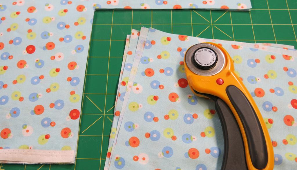 Cut away an 8" square from all four corners (or, if you do not want to use a ruler and rotary cutter, make an 8" paper pattern and