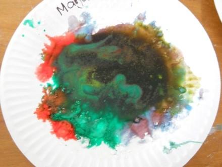When vinegar wets Bicarbonate of Soda it reacts and bubbles up like a volcano erupting. The colours also blend to create new colours.