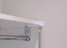 sidewall brackets). Make sure that the tab is engaged between the sidewall bracket and the wall return. b. Secure the piece to the shelf using a #6 x 5/8" flat head screw.