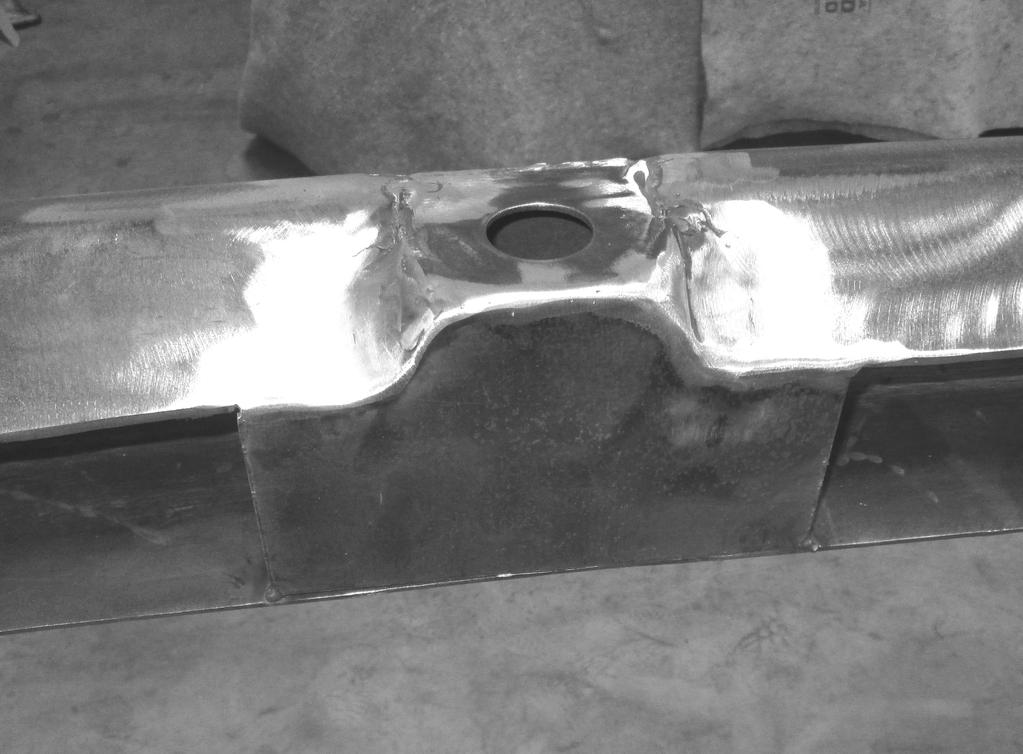 Weld backing plate to lower rail flange with two 1/2 long beads at either end.