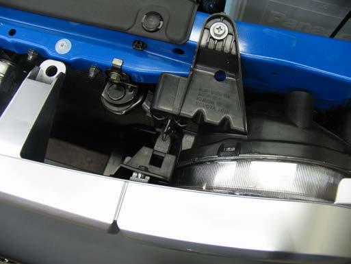 Rotate the retainer clip and insert into the back side of original bracket location to open the area for baseplate installation.