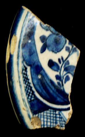 19 (No 7-38) 1111 Cover 1 160mm 92 One tin-glazed earthenware shard, part of a cover, decorated in dark cobalt blue with a complex pattern of flowers, foliage, broad and narrow bands and