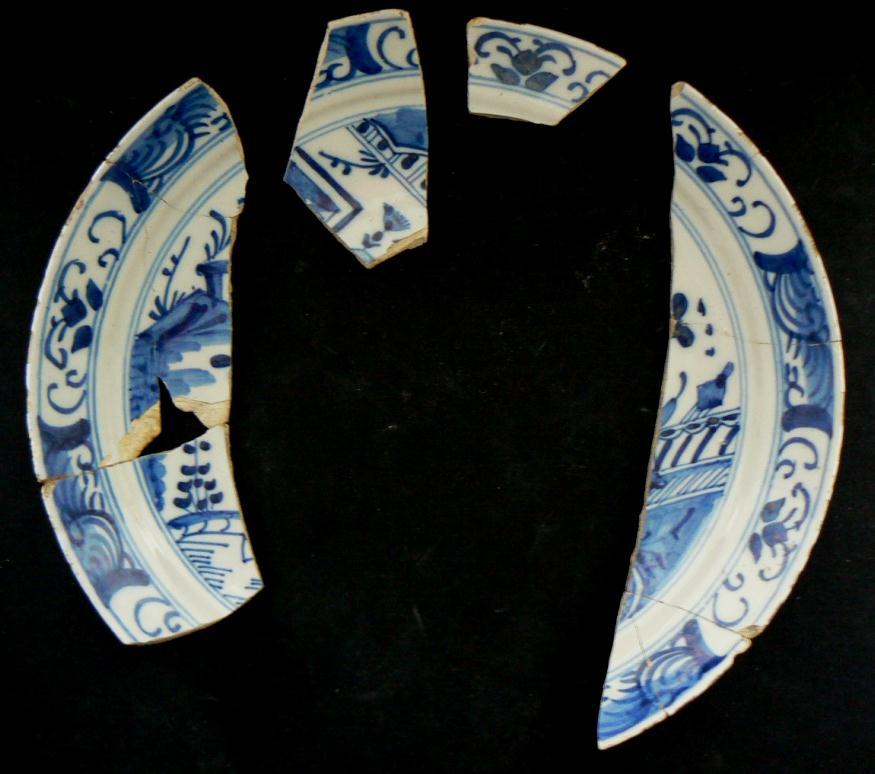 2 (No 7-2) 1162 Plate 10 230mm & 58 Ten tin-glazed earthenware shards of which five & four conjoin from a dished plate in a sandy offwhite paste
