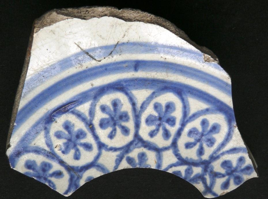 a large bowl decorated on its exterior with three blue painted bands below a band