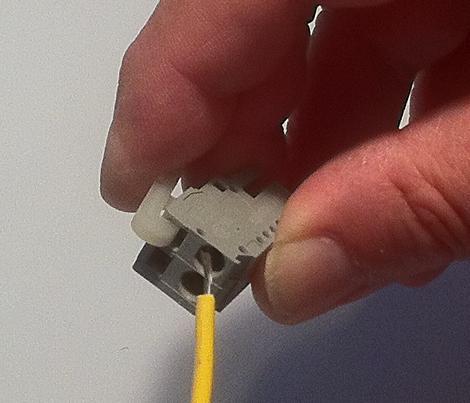 Press down on the installation tool to use it as a level which will open the connector s contacts to insert a wire.