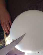 - glue, scissors, a balloon, yarn and eggs Step 1: Cut yarn into four inch strips.