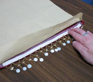 Turn the fabric right side out and press the seams. Optional: Cut two strips of beaded trim to the width of the ends of the placemat.