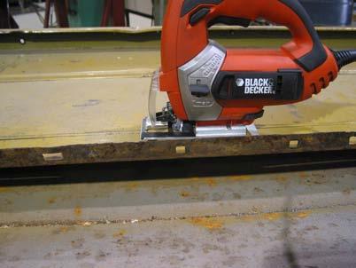 Using a jigsaw or other suitable cutting device saw along this radius out to the bottom as shown.