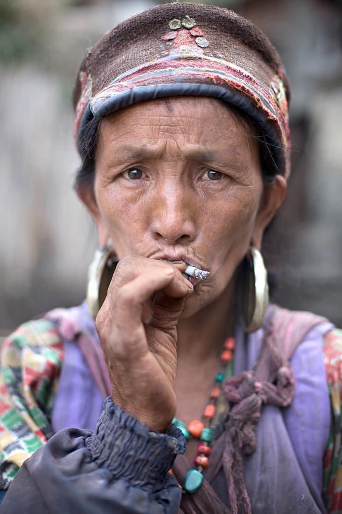 Jose Vegas, 2014, Kathmandu, Kathmandu District, Central Nepal Tamang Woman Smoking Tamang people are commonly characterized for wearing big round earrings and a Tamang
