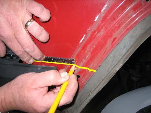 Using a putty knife, carefully remove the Cherokee emblem, taking