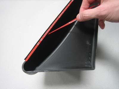A) Peel two to three inches of red vinyl backing away from edge trim tape.