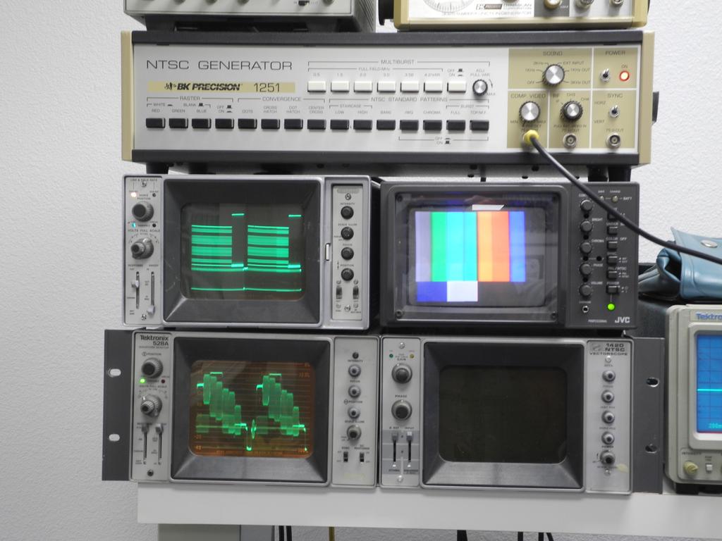 p. 6 of 13 Fig. 7 NTSC signal generator and Tektronix waveform monitors (left) and Toshiba video monitor (right) showing color bar test signal.