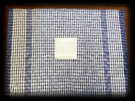 If a check pattern tea towel is not available, draw lines on the cloth with a marker. N.B.
