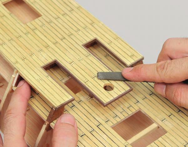 d Using a file or sandpaper, sand the wooden strips
