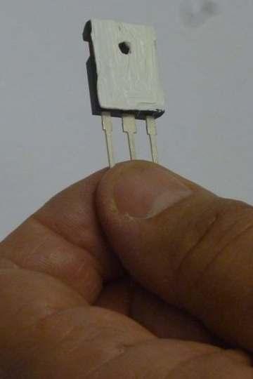 One of the screws is visible in Figure 17, the other is hidden behind the large output capacitor. 3. Place a thin film of thermal compound on the metal tab surface of Q5 as shown in Figure 7.