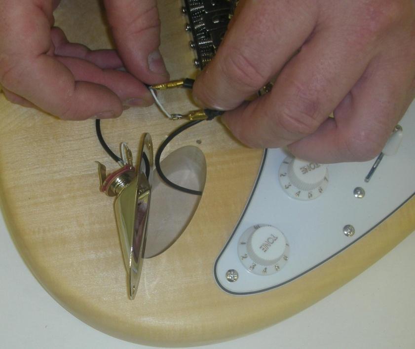 Now position the pick-guard over the front of the body so that pickups and all wiring sit neatly