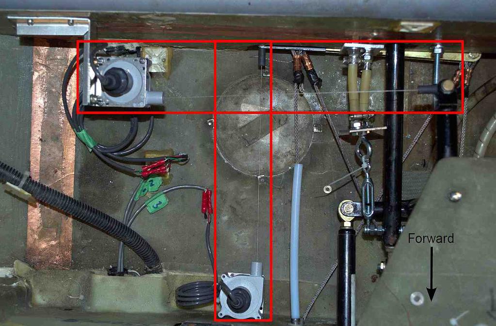 CHAPTER 2. KATANASIM HARDWARE 22 Figure 2.7: String potentiometers attached to modified control rods beneath the baggage compartment for measuring yaw and roll inputs.