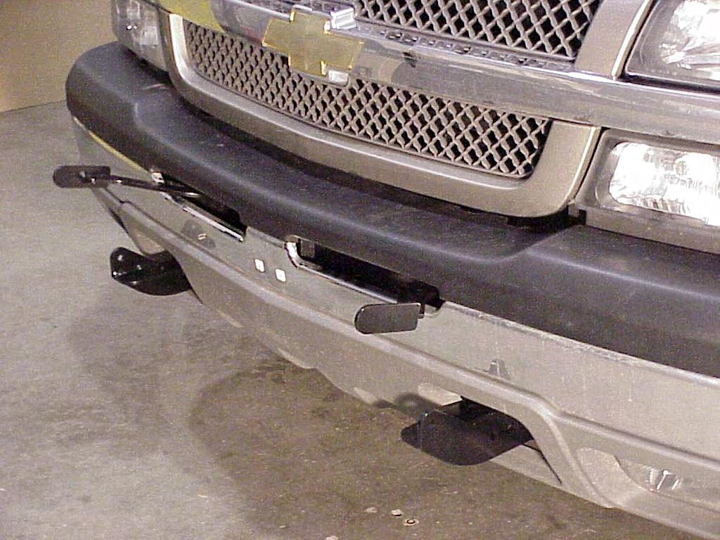 6. Reinstall the bumper and grille. Take care to center the bumper side to side before final tightening. Insert the Upper Brackets thru the bumper slots.
