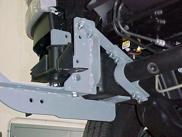 4. Using the holes in the Frame Extensions as guides, drill a 7/6 hole thru the bottom of the frame at the rear end of the brackets.