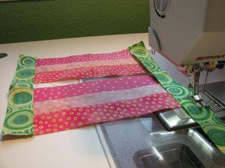 Sew a green strip across the 3½" ends of each pink section.