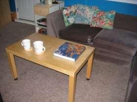table is a form of furniture with a flat horizontal upper surface, used to support objects of interest, for storage, show etc.