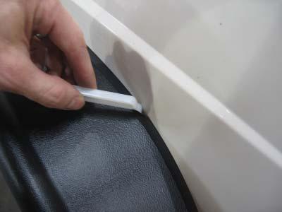 53 54 Starting at one end, place the fl at edge of the supplied edge trim tool between the lip of the edge trim and the