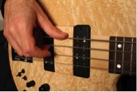 When playing on the low strings you should try muting the open strings with parts of the left hand.