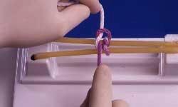 index finger of left hand to draw purple strand through the loop.
