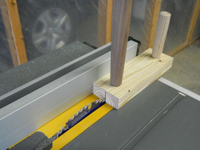 Cutting the tenon wedge slot with a simple jig and table saw blade: Contrasting wood wedges are cut to match the tenon hole diameter.