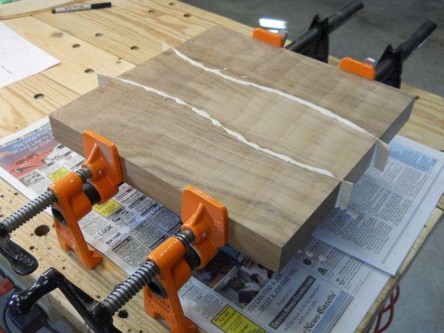 Seat sections and filler strip glued together: The seat blank is cut out slightly oversize and mounted to the lathe faceplate with four screws.