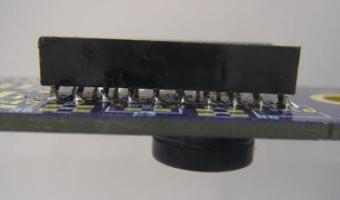Install the speaker in a manner similar to the pushbutton switches. Solder one lead then, while the solder is still flowing, press the speaker firmly against the PCB while the solder cools.