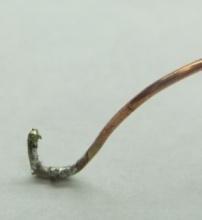 Bend the wire to form a small hook at the end and apply solder to it, the pad and the pin.