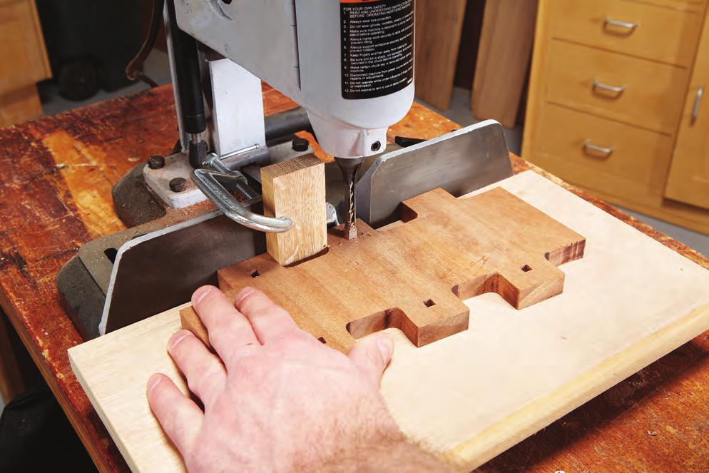 4Cut stopped square holes in all the fingers with your mortiser. To assure that the holes are precisely centered, use a clamped-on indexing block to position the workpiece.