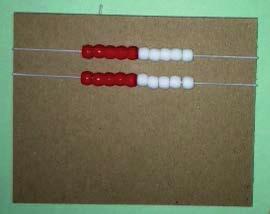 T: Let s make a Rekenrek. Put your red beads on top of your red dots and your white beads on top of your black dots, counting as you go.
