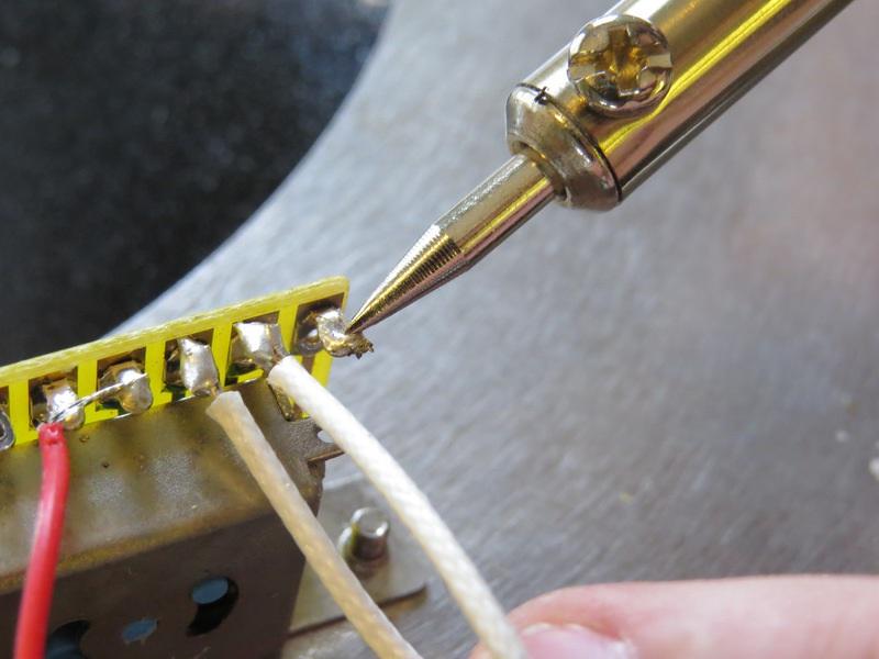 Melt the solder that is still on the selector switch terminal and quickly remove the excess solder from the terminal.