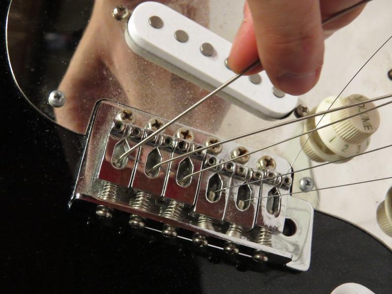 Step 3 Remove the Strings from the Bridge After removing the strings from the tuning pegs,