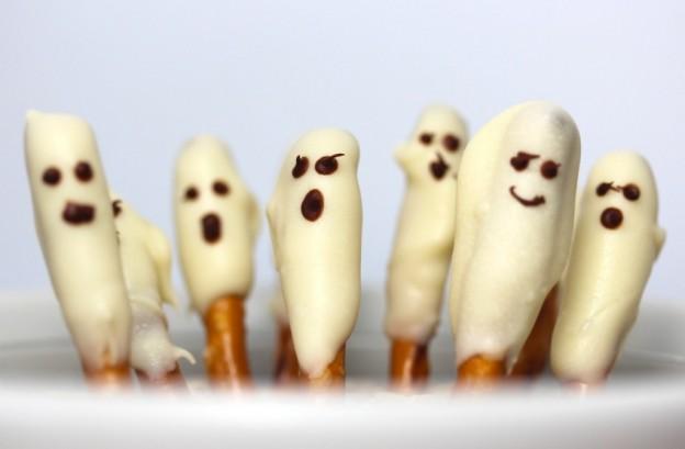 Boo Bars Pretzel Rods White candy melts Mini chocolate chips Bowl Microwave Wax paper Purchase materials Pour candy melts into a bowl Microwave them until melted Dip a