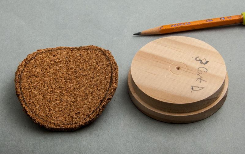 Place a multipurpose plate on the bad side and trace a circle with pencil. Then cut out a circle of cork with scissors about 1/8 outside the pencil line as in Figure #30.