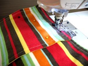 Sew a 1/4 inch seam along the sides and bottom edges of the front