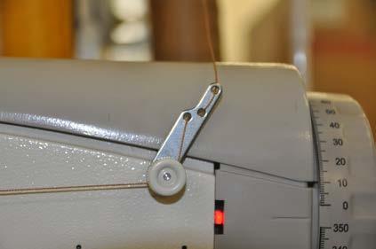 - Insert the empty bobbin on the winder. - Press the winder lever 4 against the bobbin. - Start sewing.