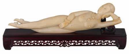 101 LOT 495 LOT 496 A fine Chinese carved ivory medicine lady, 1st quarter 20thC, laying on a matching wooden couch shaped stand, H