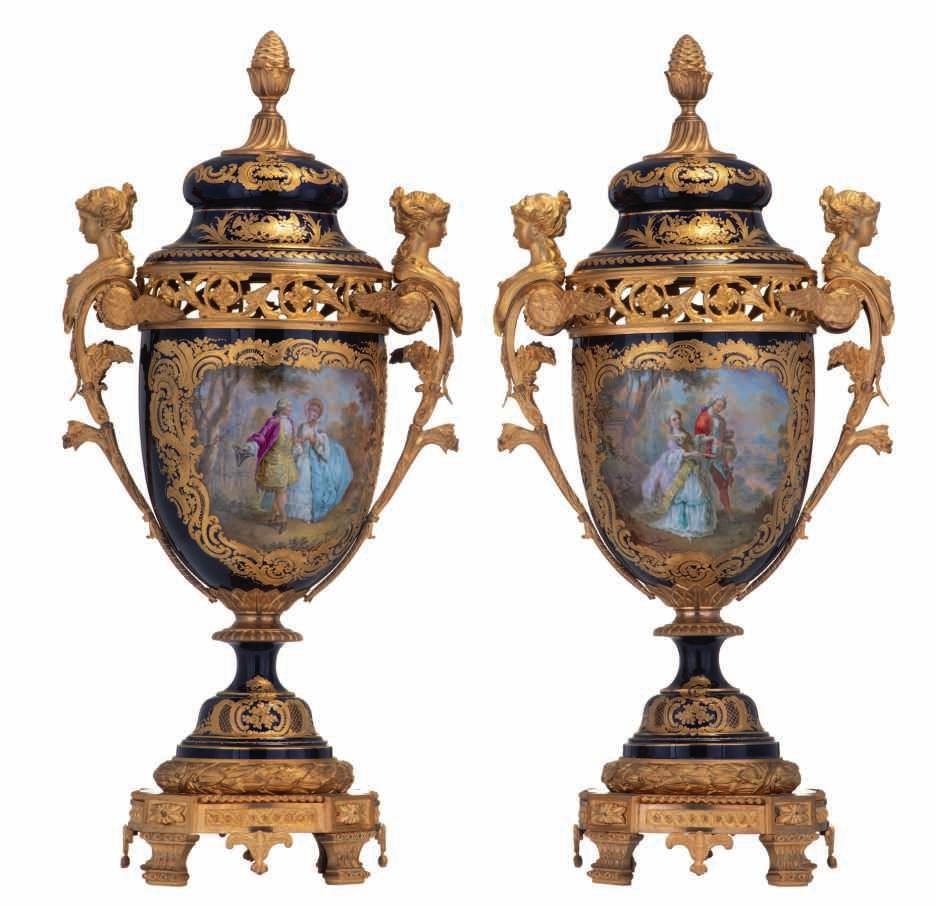 137 LOT 667 A fine pair of Sèvres ornamental vases and covers, gold-layered bleu-royalground, decorated with